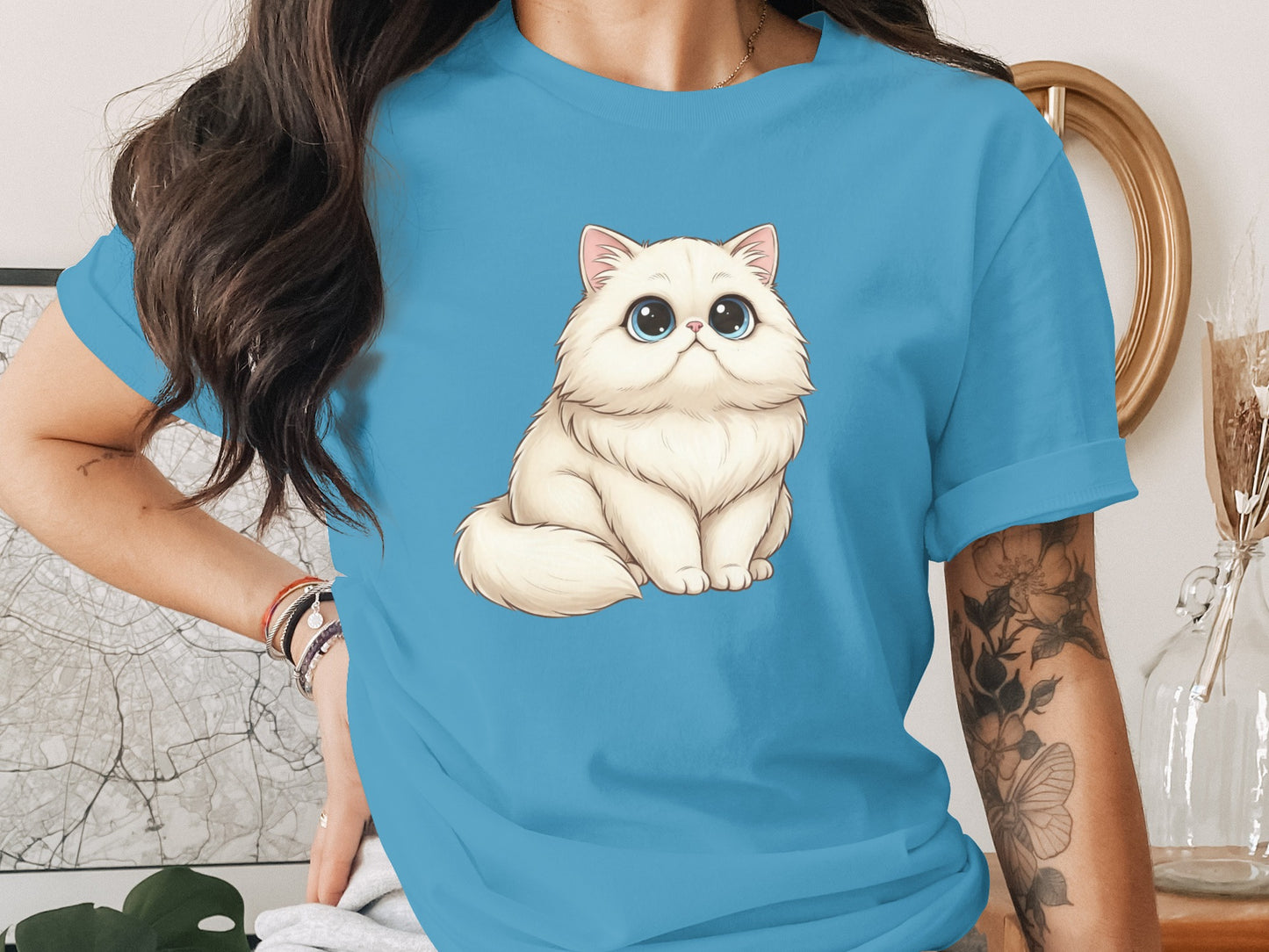 Adorable Big-Eyed Cat Illustration on Blue Shirt